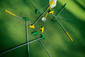 A pile of golf clubs around a flag